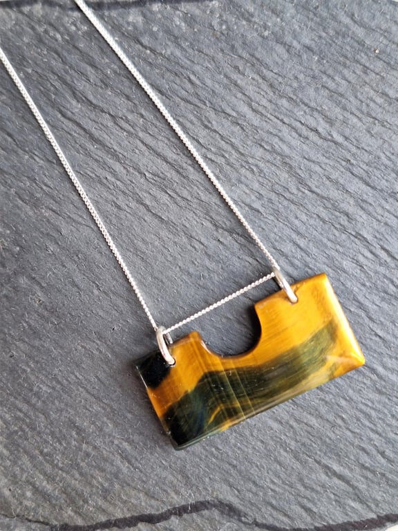 Tiger eye pendant on silver chain.