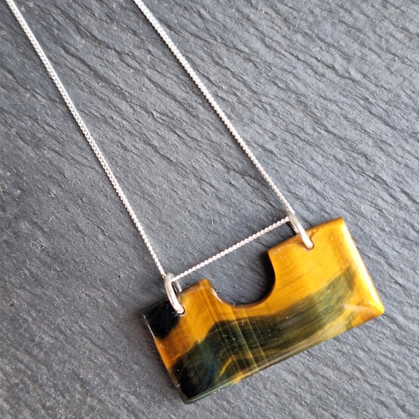 Tiger eye pendant on silver chain.