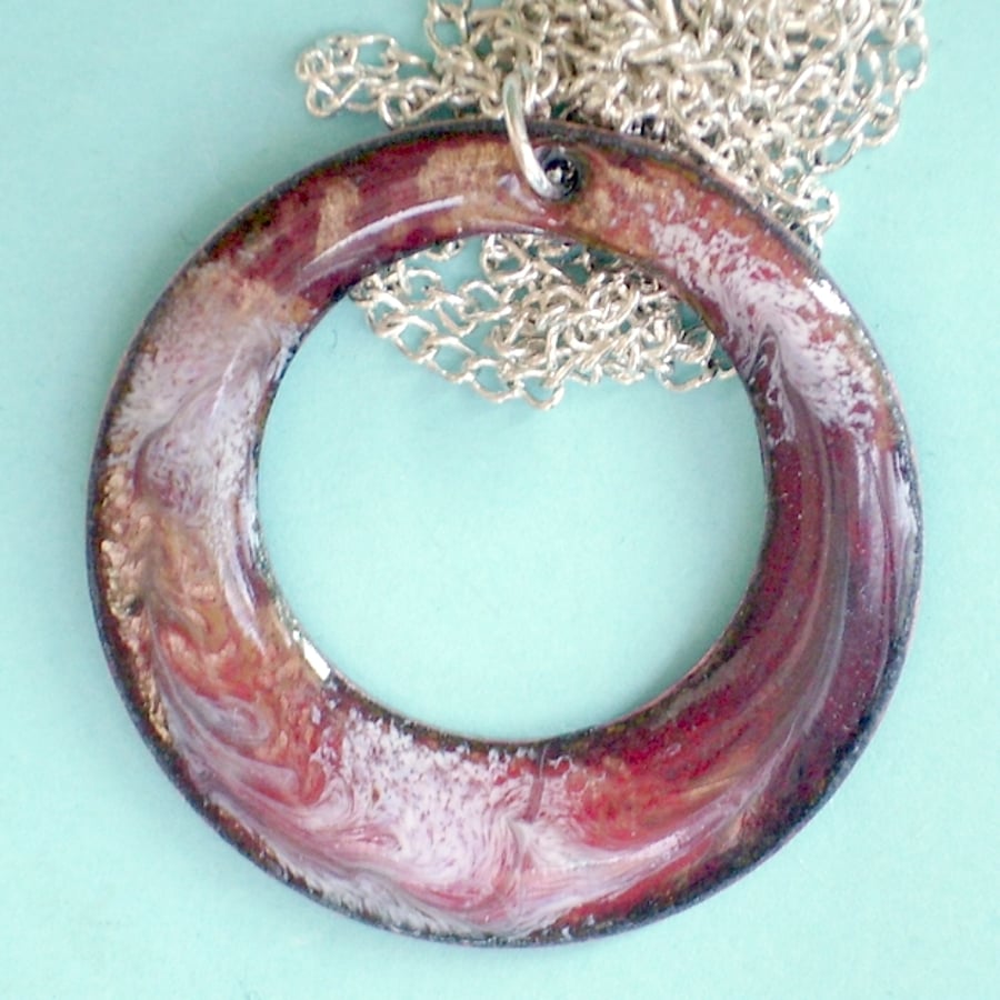 enamel pendant - pierced circle, scrolled white on dark red