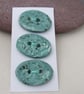 3 Medium Oval Eggshell Blue Brocade Pattern Ceramic Buttons - Image 1