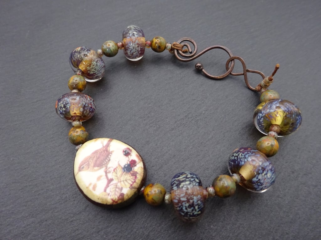 brown lampwork glass bracelet, ceramic sparrow 