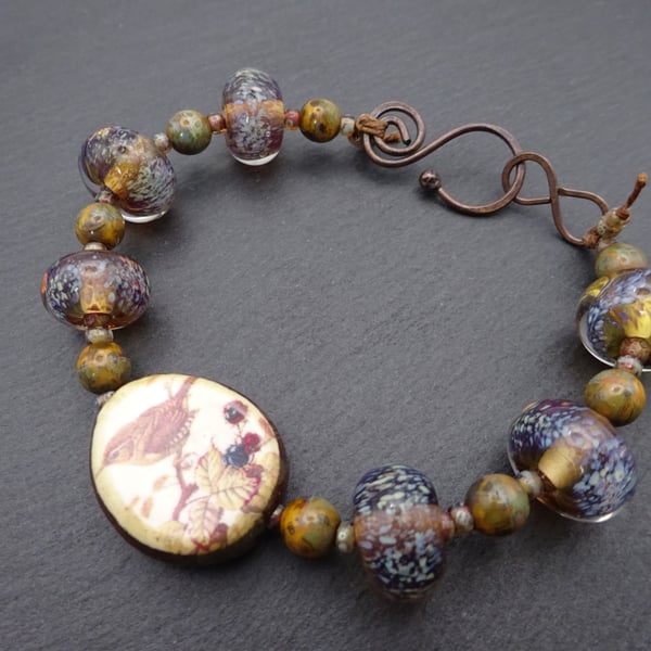 brown lampwork glass bracelet, ceramic sparrow 