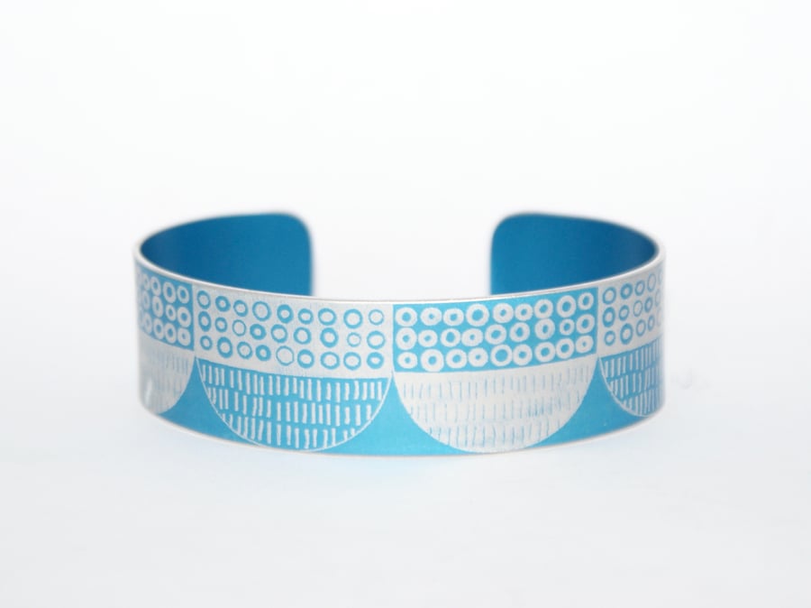 Seed head pattern aluminium cuff blue