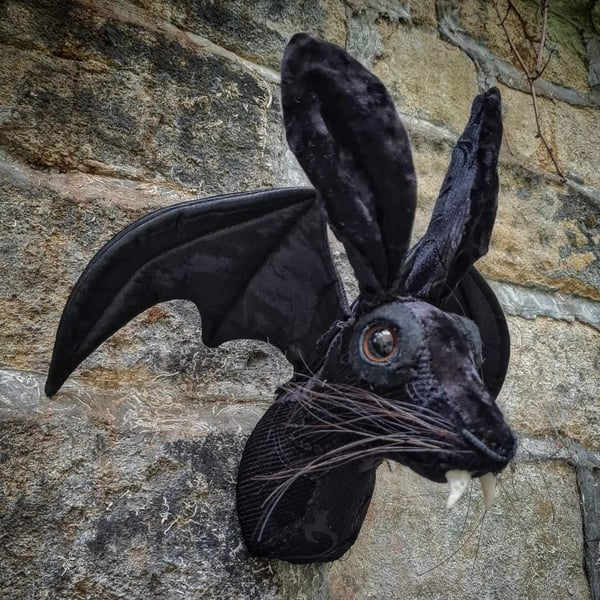 Faux hare head with vampire fangs and bat wings