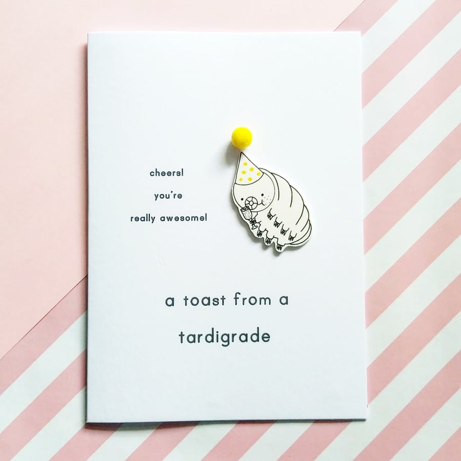 congratulations card - a toast from a tardigrade - yellow pom pom hat