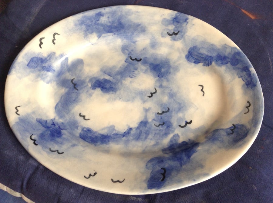 Oval platter with cloud and birds decoration