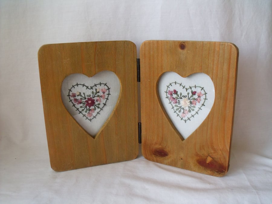 two heart embroideries in a rustic double heart picture frame