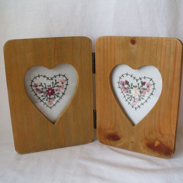 two heart embroideries in a rustic double heart picture frame