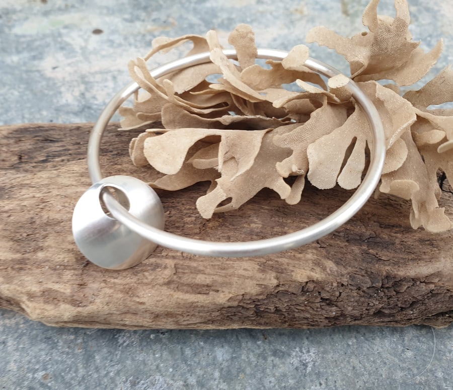 Brushed silver bangle with silver bead