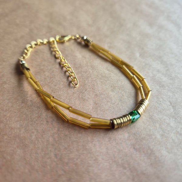 Double wrap explorer bracelet, with green coloured glass.