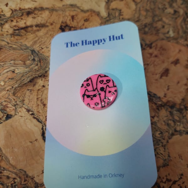 pink polymer clay pin badge with comical cats screen printed on