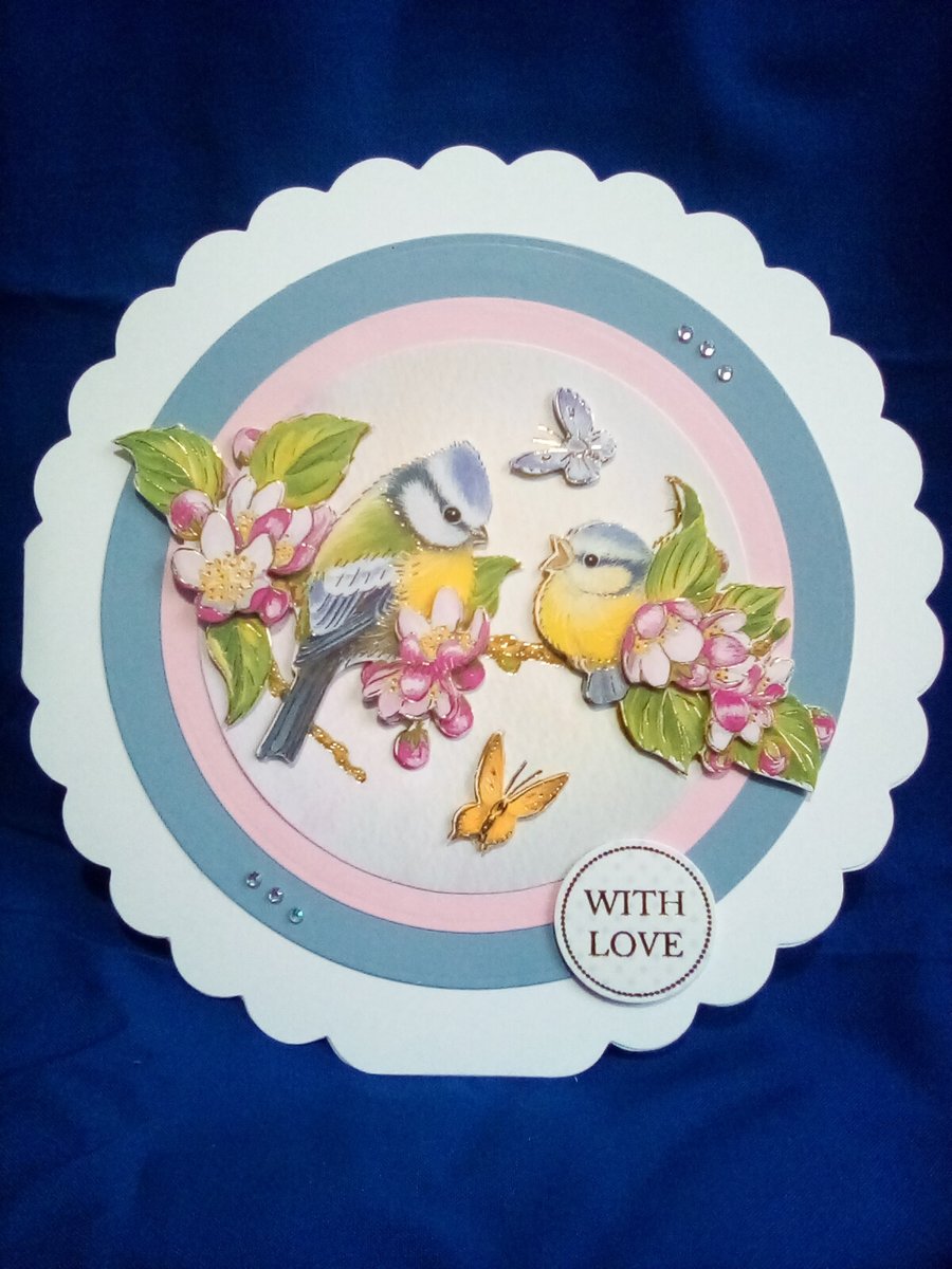 A beautiful decoupage circular card is Bluetits and blossoms