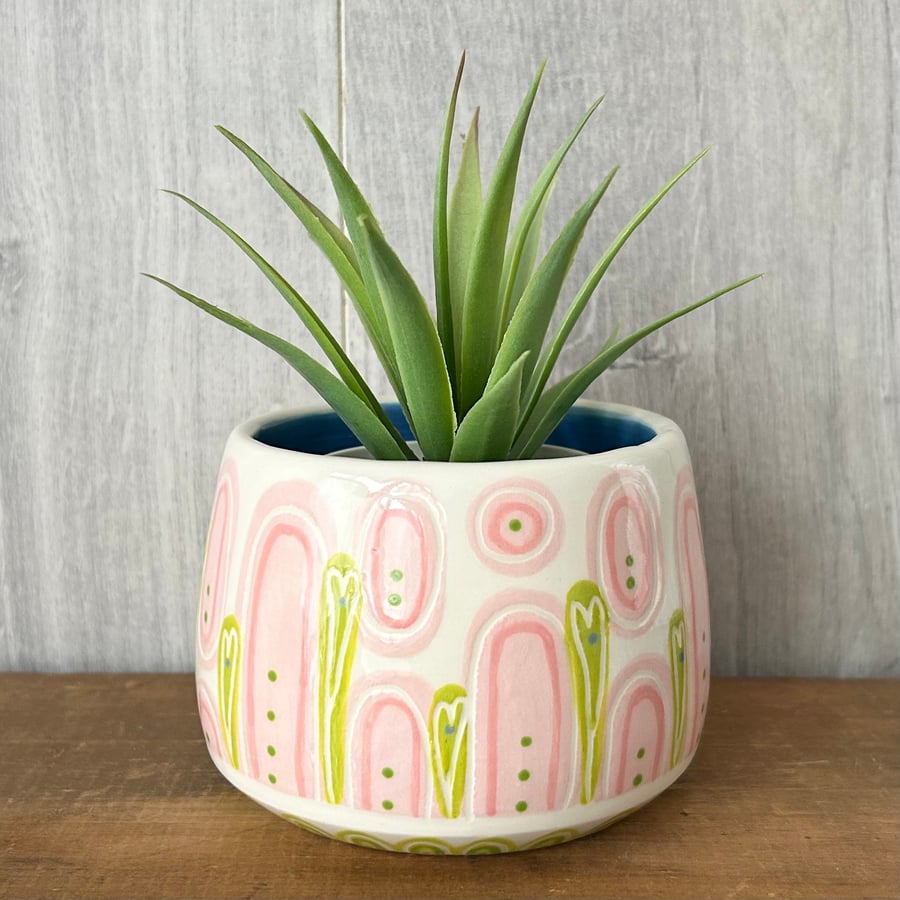 Ceramic hand thrown pot with unique pink and green pattern