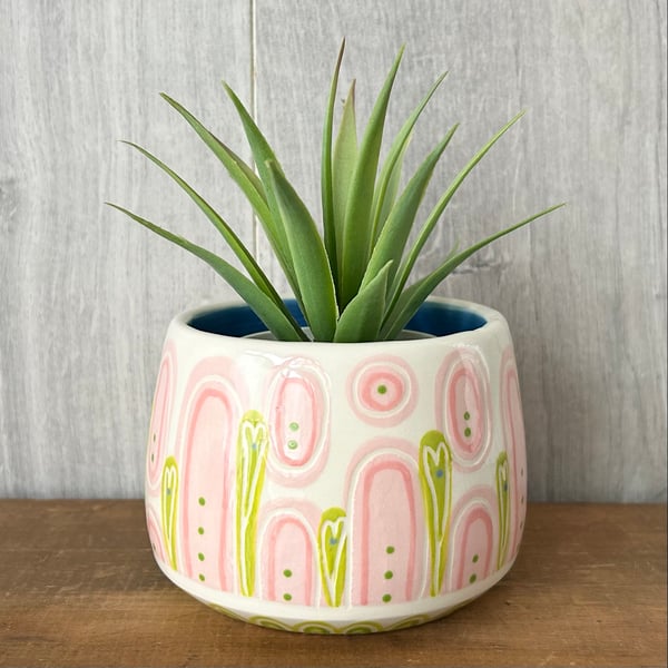 Ceramic hand thrown pot with unique pink and green pattern