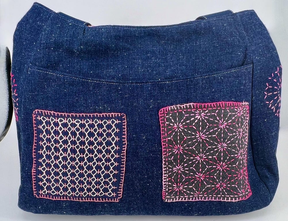 Handmade denim fully lined hobo bag with pockets and pink hand sewn Sashiko patc
