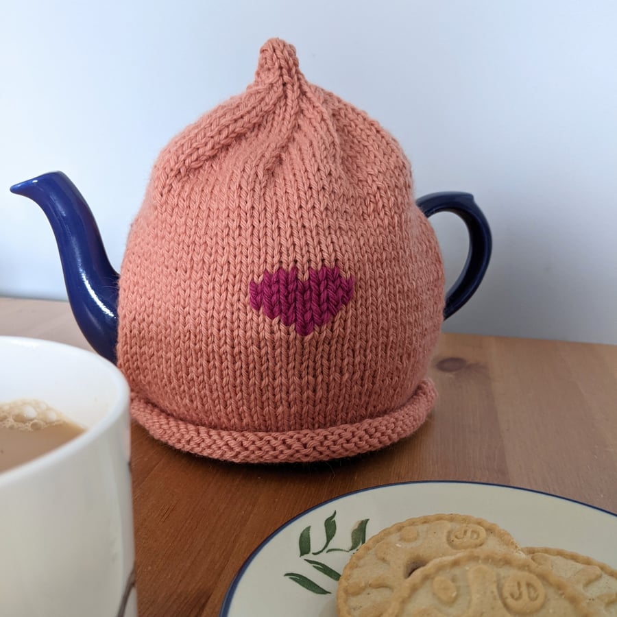Pretty pink hand knitted tea cosy