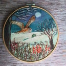 Embroidered barn owl in a winter landscape 