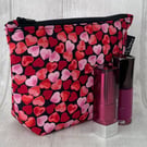 Cosmetic bag , hearts on black