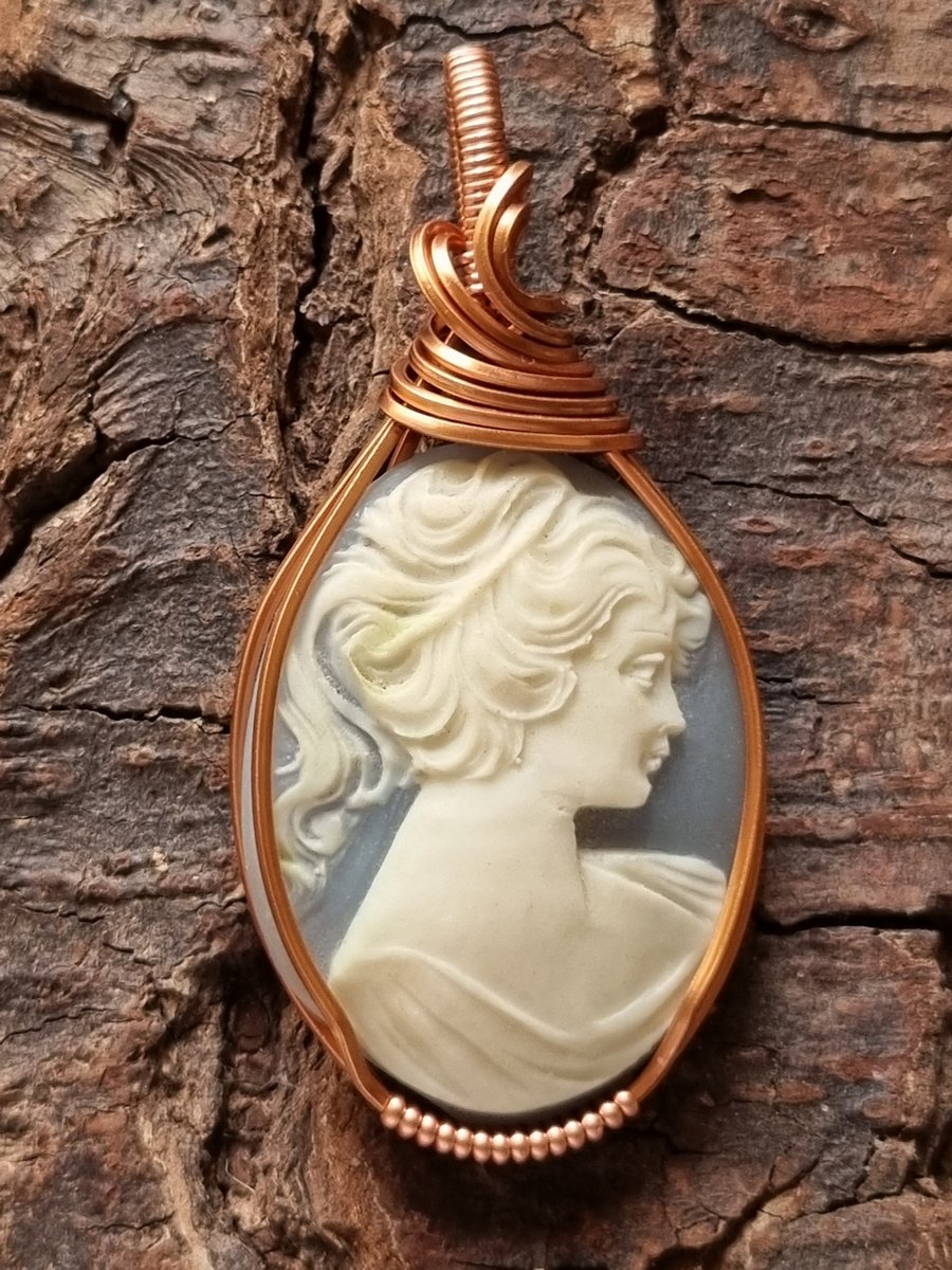 Carved blue and white cameo wire wrapped pendant in copper wire 
