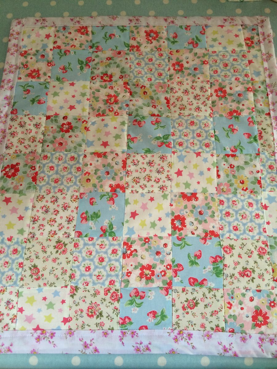 Patchwork blanket in cath kidston fabrics and pink fleece back 