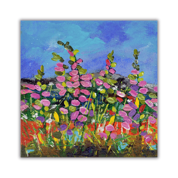 A framed acrylic painting of pink wildflowers against a blue sky