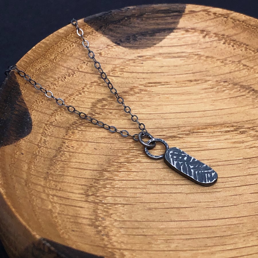Oxidised recycled silver pendant with hammered texture.