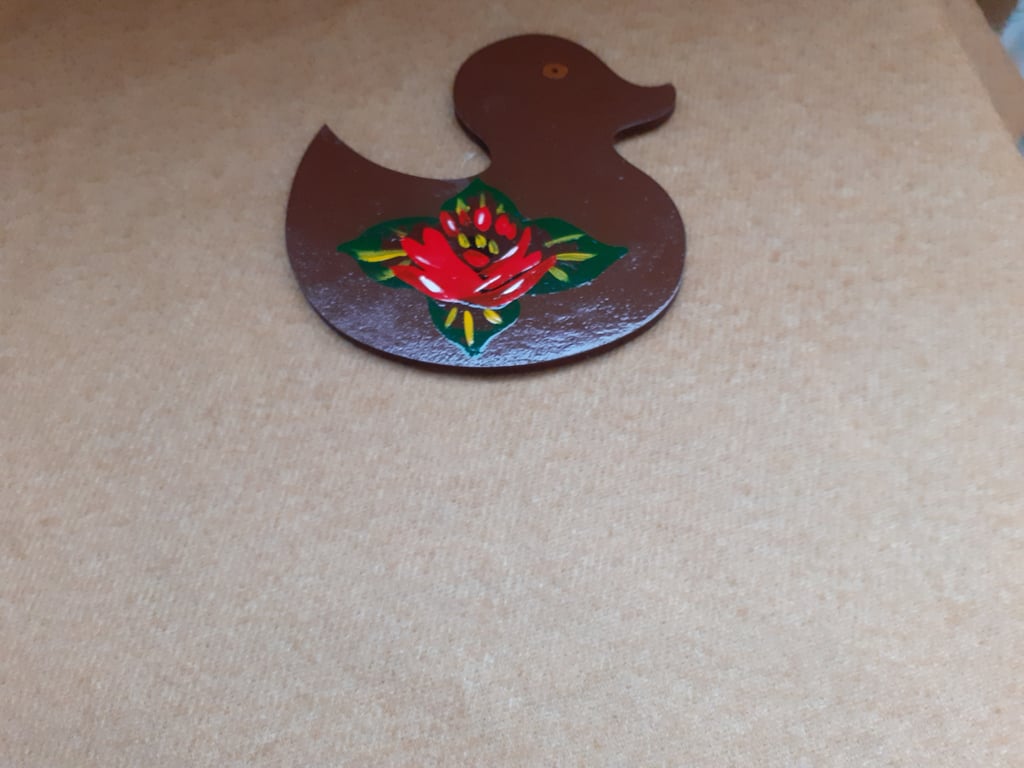 Brown duck shaped fridge magnet with canal art style rose.