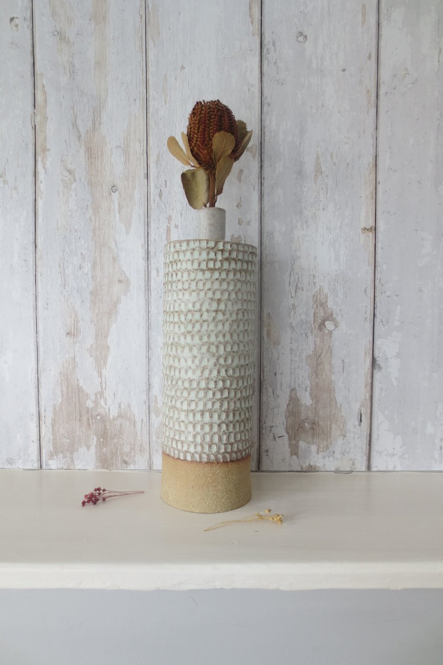 Hand-built stoneware pottery carved bottle in matt white glaze