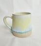 A handmade stoneware mug in yellow, green and oatmeal - Image 1