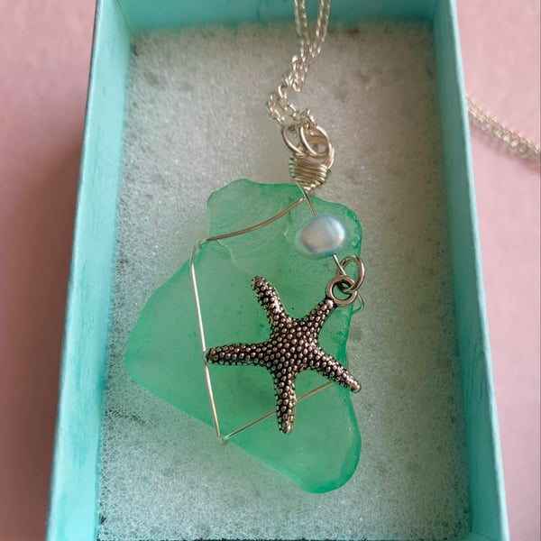 Beautiful handcrafted aqua sea glass pendant with silver starfish.  Unique gift.