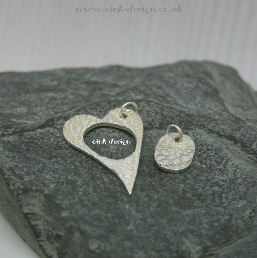 Mummy and Me. Two fine silver patterned pendants