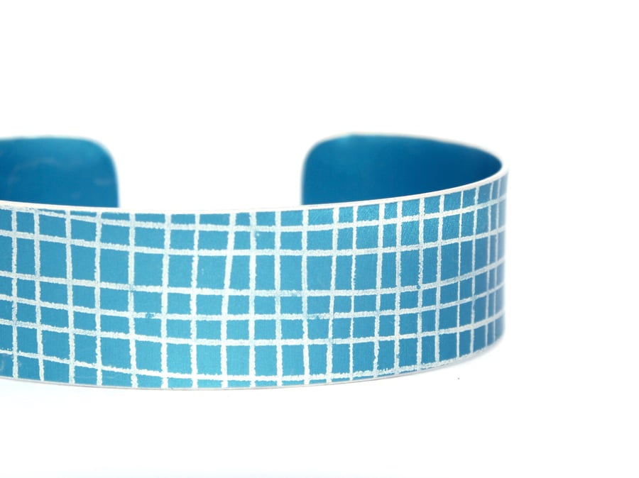 Dark blue criss cross aluminium cuff