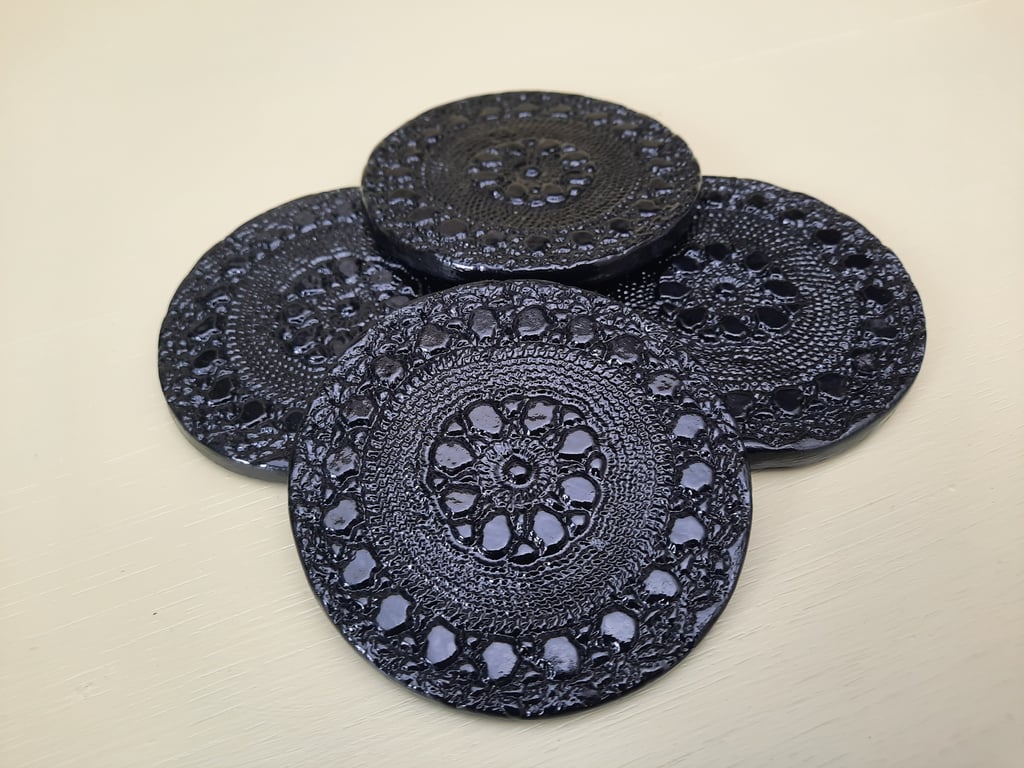 Set of 4 black embossed clay coasters drink mats