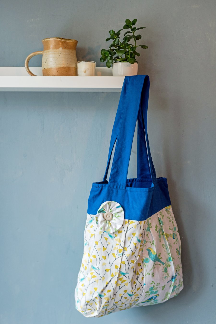 Bird print tote bag with flower button detail