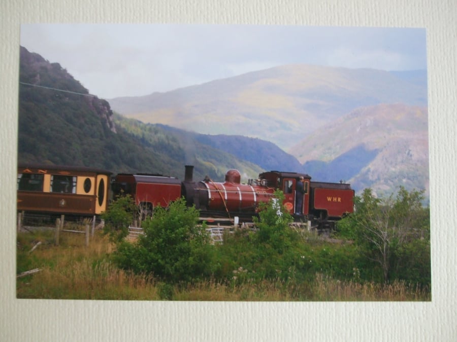 Photographic greetings card of a Welsh Highland Railway steam train in dark red.