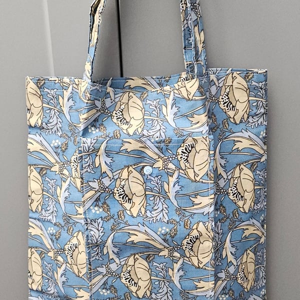 Blue floral fold up tote bag.