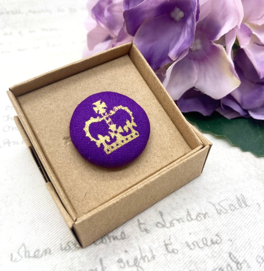Gold crown on purple fabric button brooch royal celebrations