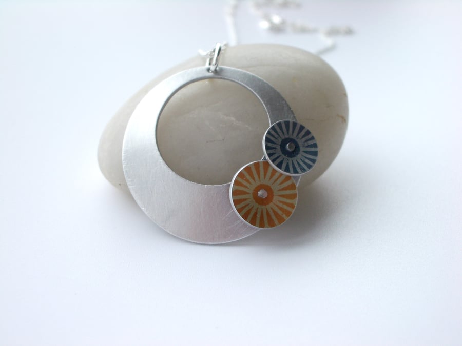 Circle pendant necklace in brushed aluminium with grey and orange discs