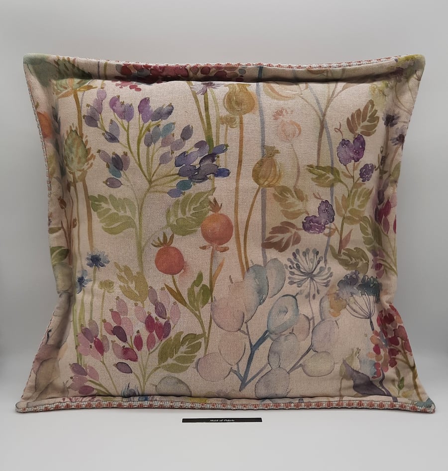 Cushion in beige floral with flange edge.