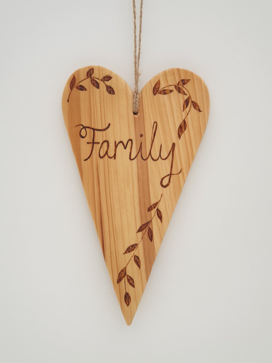 Family rustic wooden heart hanging decoration decorated using pyrography 