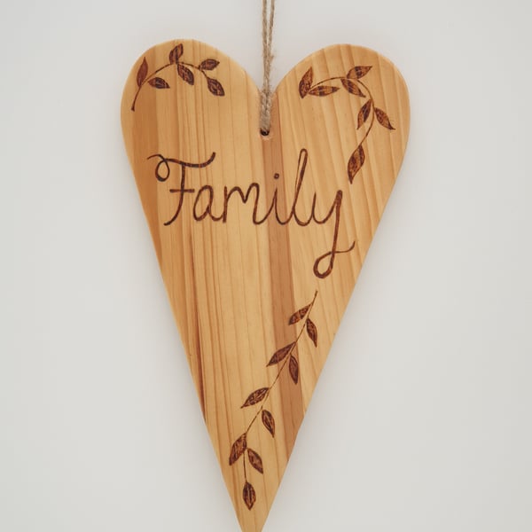 Family rustic wooden heart hanging decoration decorated using pyrography 