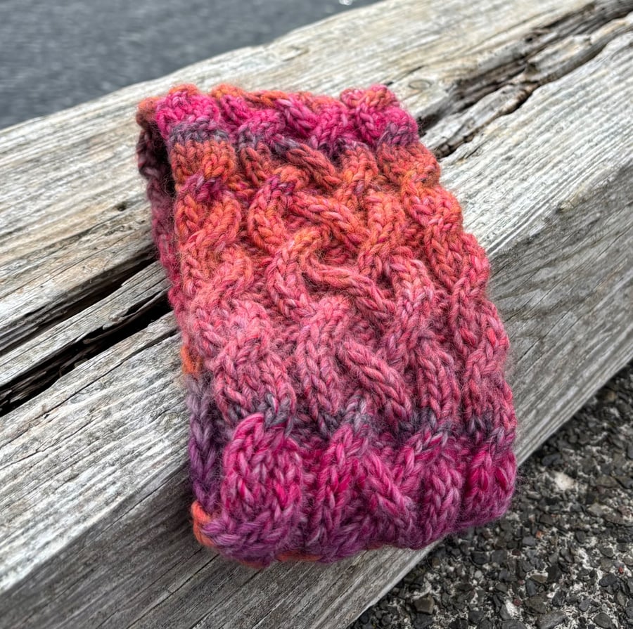 Hand knitted , lined headband featuring Celtic knot pattern.
