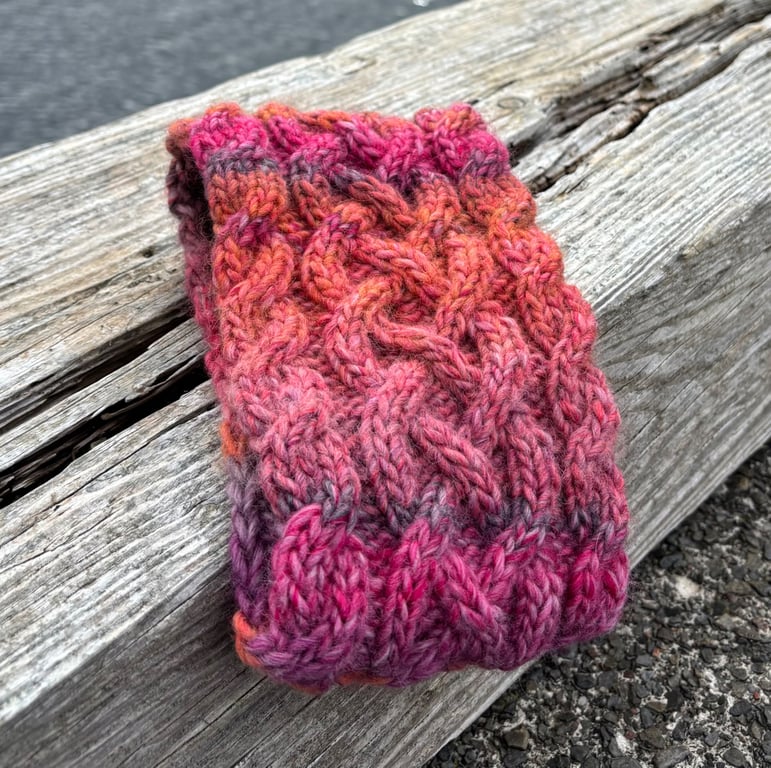 Hand knitted , lined headband featuring Celtic knot pattern.