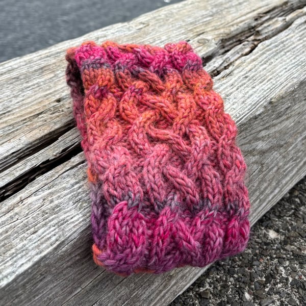 Hand knitted , lined headband featuring Celtic knot pattern.