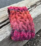 Hand knitted , lined headband featuring Celtic knot pattern.