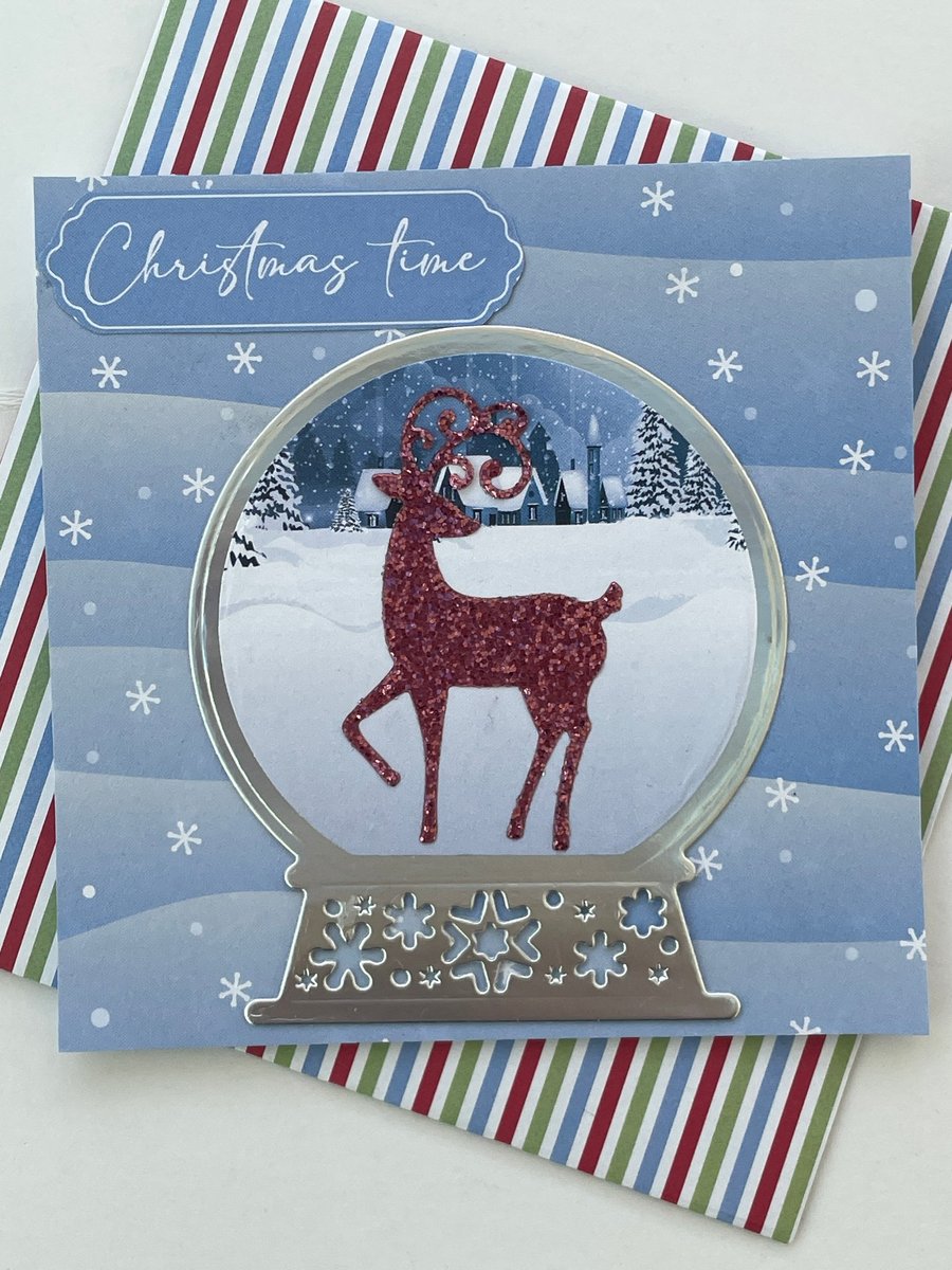 Glittery stag in a snow globe Christmas time card