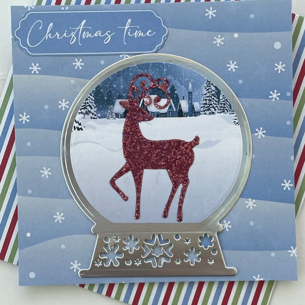 Glittery stag in a snow globe Christmas time card