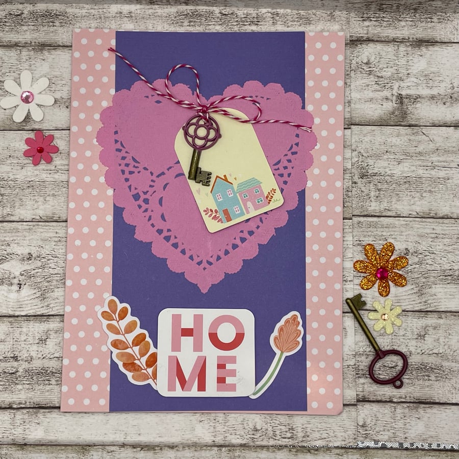 Pretty polka dot new home card with key detail in pink and purples