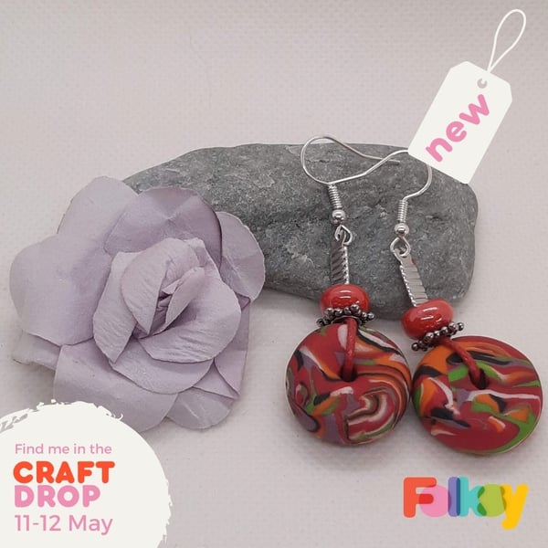 Colourful dangly earrings in a polymer clay swirl design