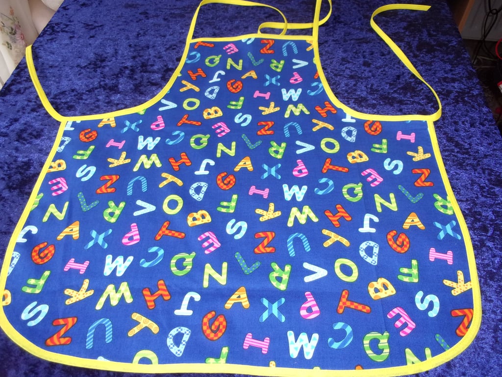 Baby Apron with Colourful Alphabet and yellow bias binding